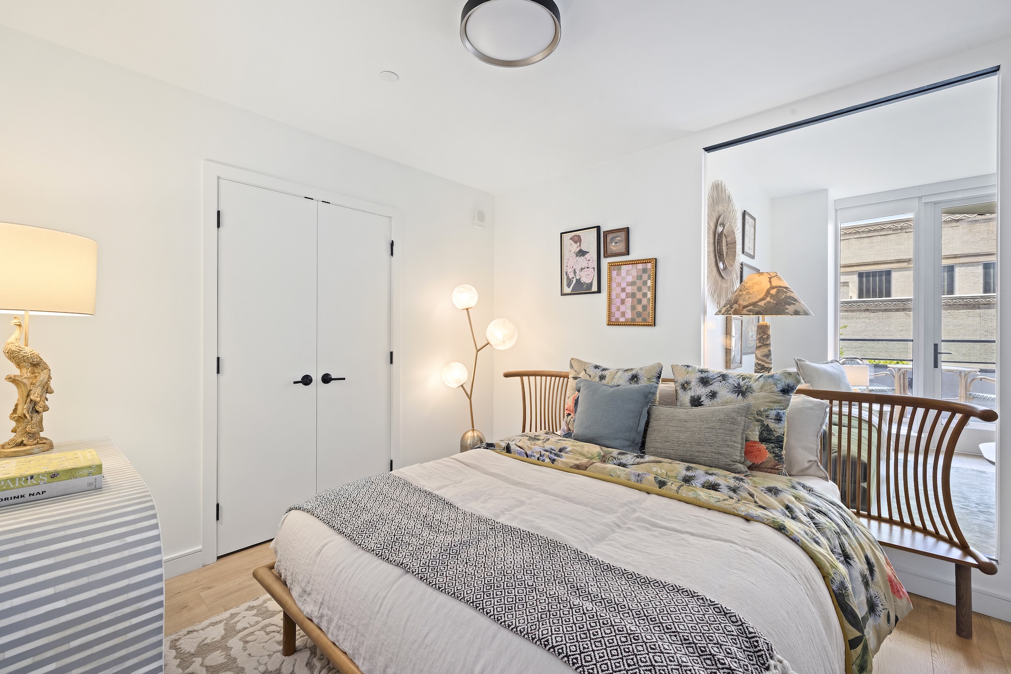 Large bedroom with large interior window that faces the living room