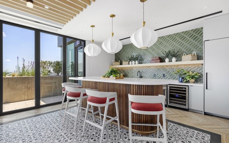 Bar built for entertaining with bar stools, pendant lighting