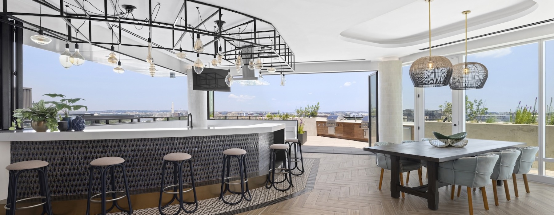 Penthouse level curved bar with large floor to ceiling windows 