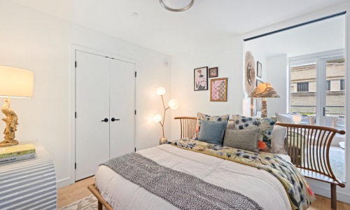 Bedroom with interior window that faces the living room 