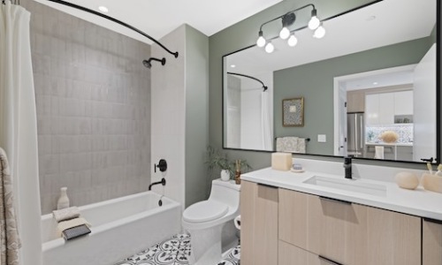 tile shower and flooring with oak cabinetry