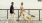 A woman and man walking with a yellow Labrador